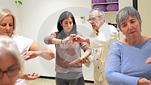 Mature women in a Qi gong class choreographing the exercises