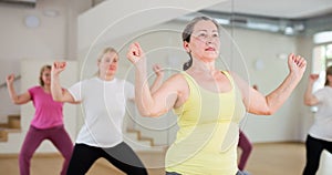 Mature women warming up before dance training