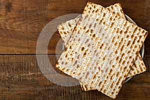 Matzah on a plate on a wooden table laid out in the form of magen david.