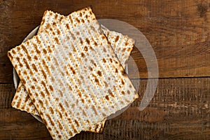 Matzah on a plate on a wooden table laid out in the form of magen david.