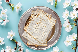 Matzah and spring flowers on kitchen table. Jewish holiday bread matza or matzoh. Happy Passover