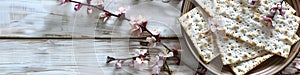 Matzah and spring flowers on kitchen table. Jewish holiday bread matza or matzoh. Happy Passover