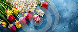 Matzah and spring flowers on kitchen table. Jewish holiday bread matza or matzoh. Happy Passover