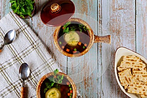 Matzo ball soup in ceramic bowls with lid photo