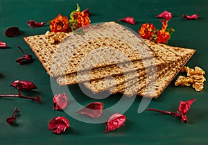 Matzo bread stack with nuts, flowers on table, creative arts display