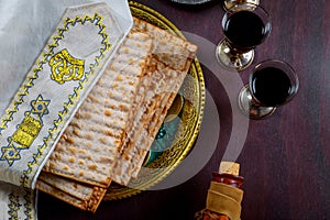 Matzo for Passover with metal tray and kosher wine on table