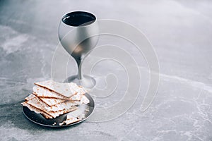 Matzos unleavened bread with kiddush cup of wine. Jewish Pesah holiday. Banner with copy space. Christian communion concept for