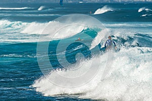 MAUI, HAWAII, USA - DECEMBER 10, 2013: Surfers are riding waves