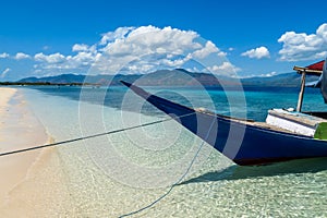 Maumere - A boat anchored to a sandy beach photo