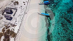 Maumere - A drone shot of an idyllic beach with boats anchored on the shore