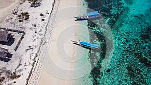 Maumere - A drone shot of an idyllic beach with boats anchored on the shore