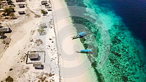 Maumere - A drone shot of a small island and the boats anchored to ist shore photo