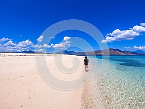 Maumere - A girl in black T-shirt walking on the beach photo