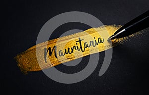 Mauritania Handwriting Text on Golden Paint Brush Stroke