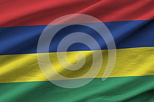 Mauritius flag with big folds waving close up under the studio light indoors. The official symbols and colors in banner