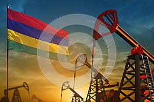 Mauritius oil industry concept. Industrial illustration - Mauritius flag and oil wells against the blue and yellow sunset sky