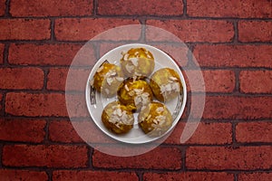 Mawa Laddu sweet topping with almonds served in plate isolated on background top view of bangladeshi dessert food