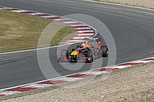 Max verstappen in a formule 1 car comes racing outof the corner on circuit zandvoort
