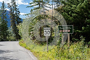 Maximum 30 km speed limit sign at Vermilion Lakes road in summer day. Banff Legacy Trail, Banff National Park