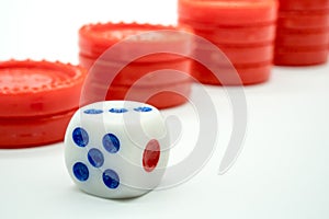 A maximum number of dice facing up against red coin rising stack photo
