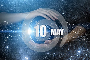 May 10th. Day 10 of month, Calendar date. Human holding in hands earth globe planet with calendar day. Elements of this image