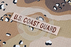May 12, 2018. US COAST GUARD branch tape on Desert Battle Dress Uniform background