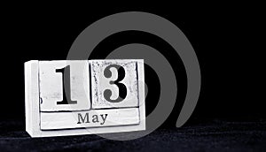 May 13th, Thirteenth of May, Day 13 of month May - vintage wooden white calendar blocks on black background with empty space for
