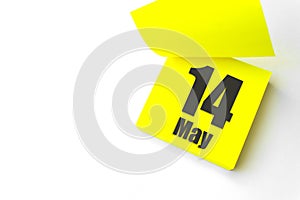 May 14th. Day 14 of month, Calendar date. Close-Up Blank Yellow paper reminder sticky note on White Background. Spring month, day