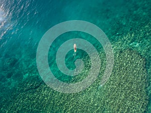 May 15 2016, Haleiwa Hawaii. Aerial view of an unknown Stand up Paddle boarder surfing in the Ocean