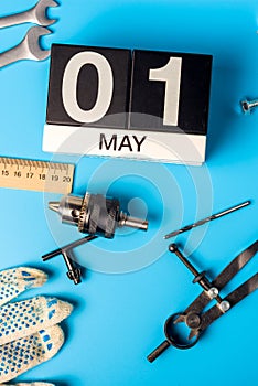 May 1st. Day 1 of may month, calendar on blue background with tools. Labor day