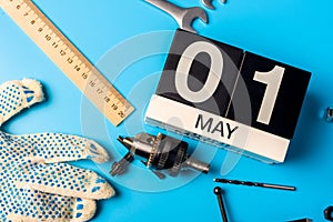 May 1st. Day 1 of may month, calendar on blue background with tools. Labor day