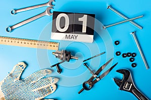 May 1st. Day 1 of may month, calendar on blue background with tools. Labour day