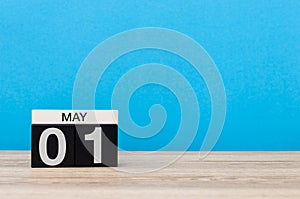 May 1st. Day 1 of month, calendar on blue background. Spring day, empty space for text. International Workers` Day