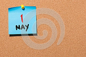 May 1st. Day 1 of month, calendar on cork notice board, business background. Spring time, empty space for text