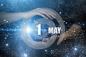 May 1st . Day 1 of month, Calendar date. Human holding in hands earth globe planet with calendar day. Elements of this image