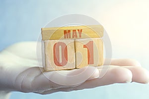 may 1st. Day 1 of month, Handmade wood cube with date month and day on female palm spring month, day of the year concept
