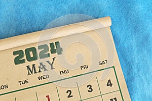 May 2024 calendar flat lay in blue background with copy space.