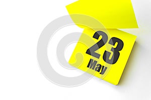 May 23rd. Day 23 of month, Calendar date. Close-Up Blank Yellow paper reminder sticky note on White Background. Spring month, day