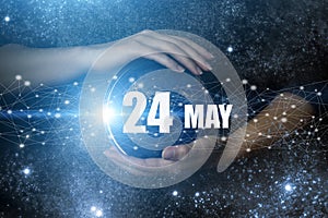 May 24th. Day 24 of month, Calendar date. Human holding in hands earth globe planet with calendar day. Elements of this image