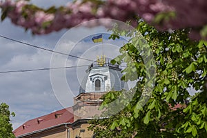 May 25, 2021 Berehove city, Transcarpathia, Ukraine. Ukrainian flag and coat of arms on a house on Tomasz Ese Street in Beregovo,