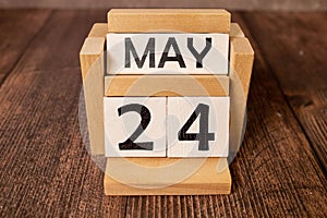 May 25th. Wooden cubes with date of 25 May on old blue wooden background.