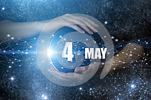 May 4th. Day 4 of month, Calendar date. Human holding in hands earth globe planet with calendar day. Elements of this image