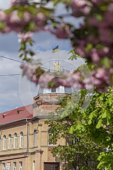 May 25, 2021 Berehove city, Transcarpathia, Ukraine. Ukrainian flag and coat of arms on a house on Tomasz Ese Street in Beregovo, photo