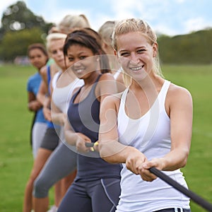 May the best woman win. a group of young woman engaged in a tug of war.