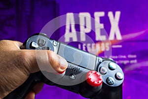 May 17, 2021, Brazil. In this photo illustration the controller for PlayStation PS and in the background the game logo Apex