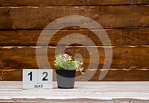 May calendar with number 12. Planner copy space on a wooden brown background. March number icon. Place for text background