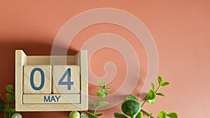 May 04, Date design with calendar cube and leaf on orange background for inserting your text2 photo