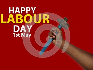 May first International Workers Day. International Workers Day with hammer in hand on Red background