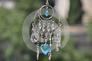 May luck be yours. Jewelry charm or talisman. Name amulet for good luck. Luck amulet hung out outdoor. Silver amulet with gems and