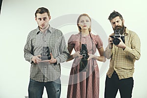 We may snap at any time. Group of photographers with retro cameras. Retro style woman and men hold analog photo cameras